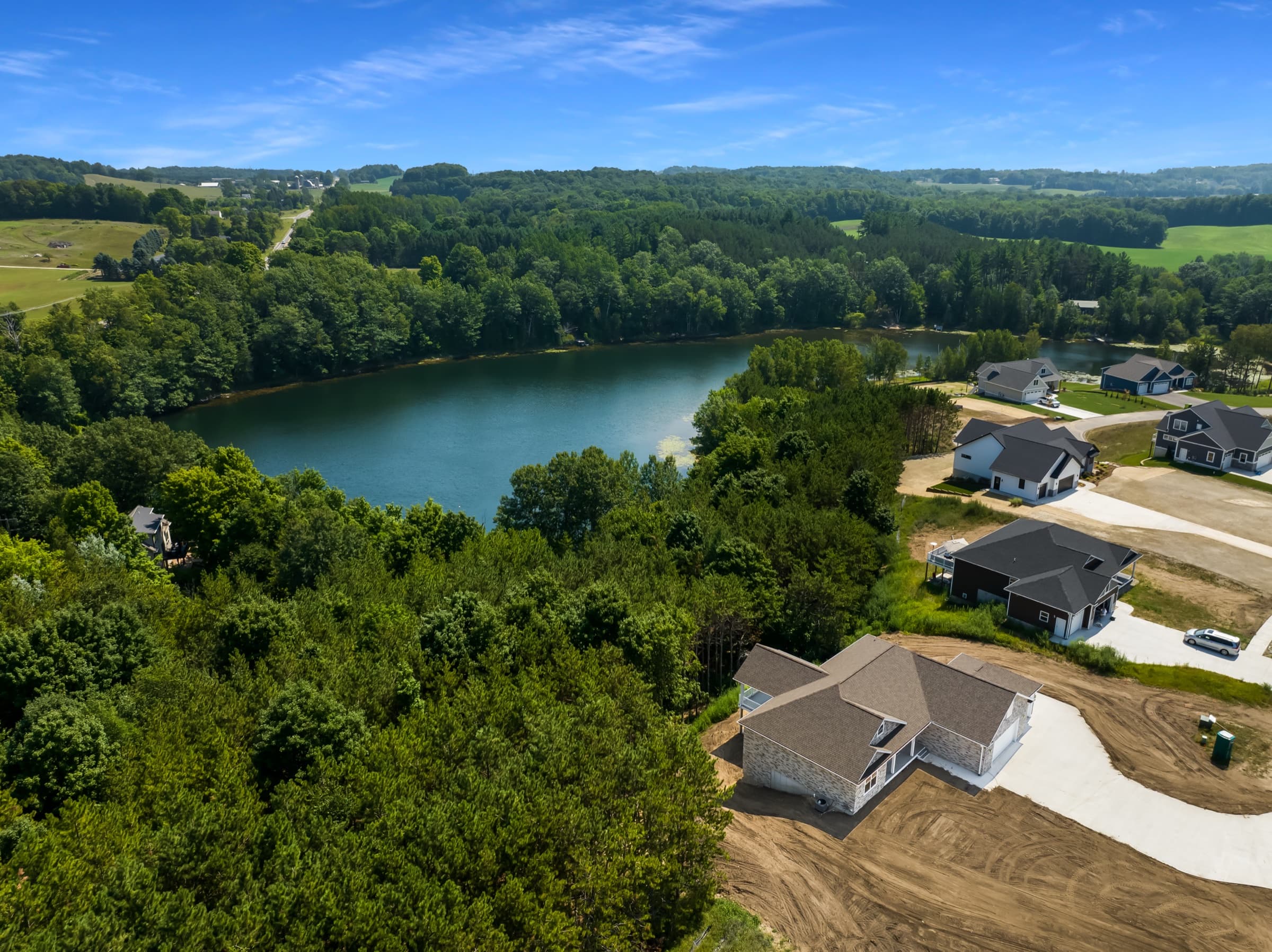 A Rock Creek Homes community from above, surrounded by northern Michigan forest